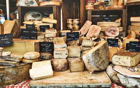 Sample French cheese at a local market