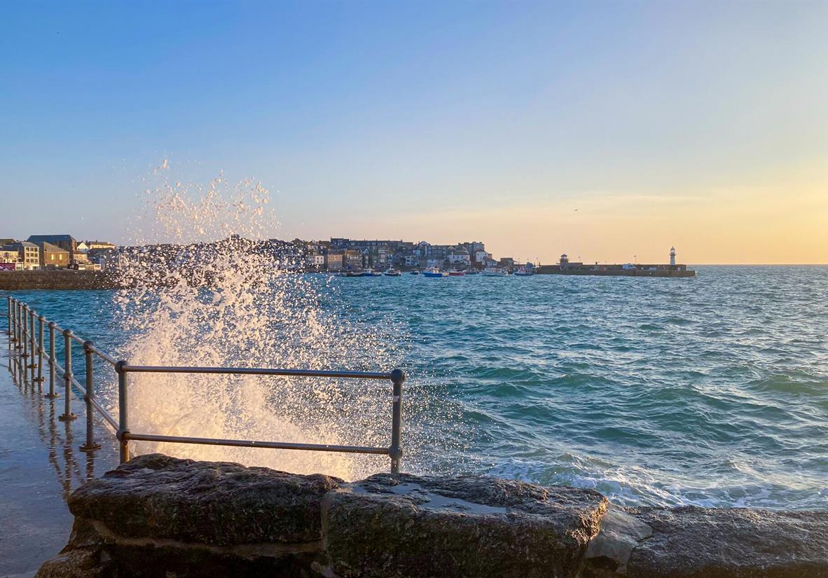 Waves crashing against the harbour