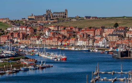 Visit Whitby Abbey that's perched above the town