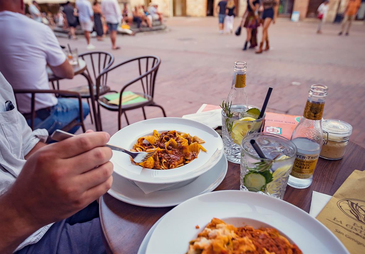 Dine on delicious pasta in a village square