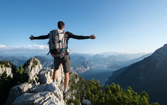 Wanderer auf dem Gipfel über dem Gardasee