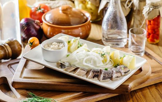 Sample local delicacies such as pickled herring
