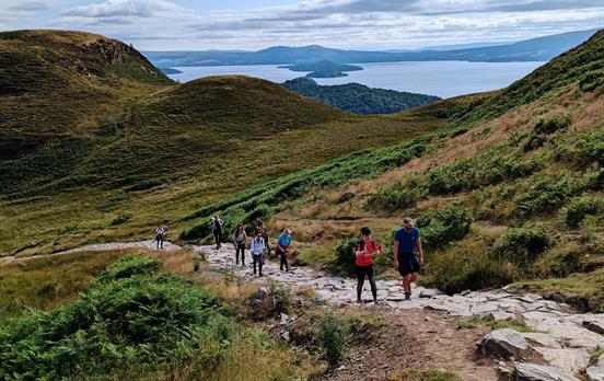 Walkers ascending up Conic Hill